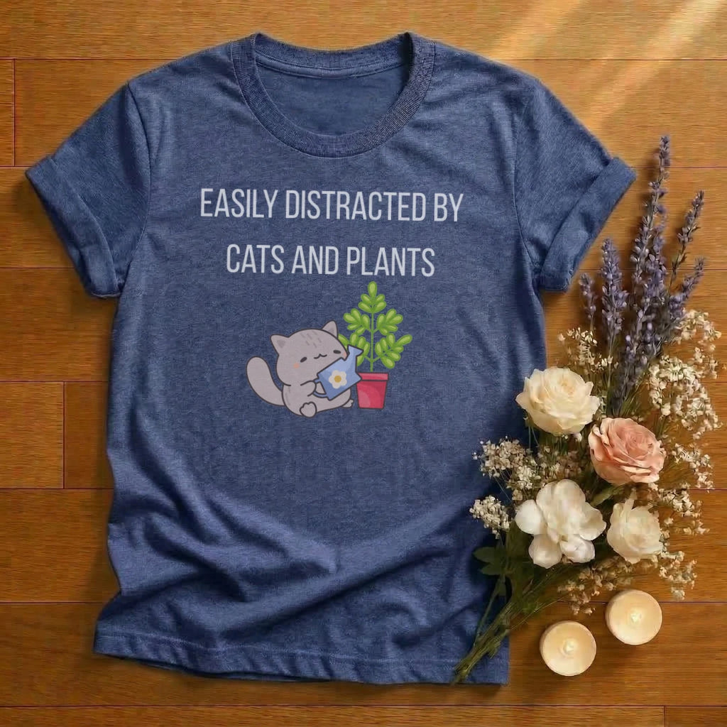 https://wescale-cdn.com/generated-mockups/666ffdf4-3d69-46d2-92d6-f61d0e656fc2/ccf916bf-38f3-4a62-a2bd-96643d4f447d/e144645b-b7d3-44e9-8c72-7c5860084014_designs/easily_distracted_by_cats_and_plants_graphic_white_1774639596262_9xzmm7.png_1774639601525.webp