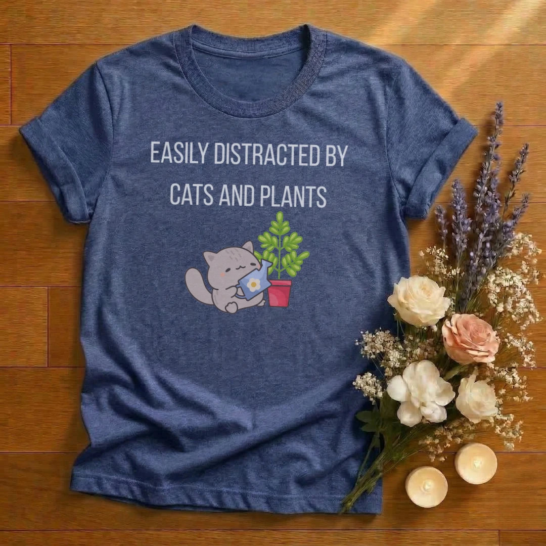 https://wescale-cdn.com/generated-mockups/666ffdf4-3d69-46d2-92d6-f61d0e656fc2/ccf916bf-38f3-4a62-a2bd-96643d4f447d/e144645b-b7d3-44e9-8c72-7c5860084014_designs/easily_distracted_by_cats_and_plants_graphic_white_1774639596262_9xzmm7.png_1774639601525.webp